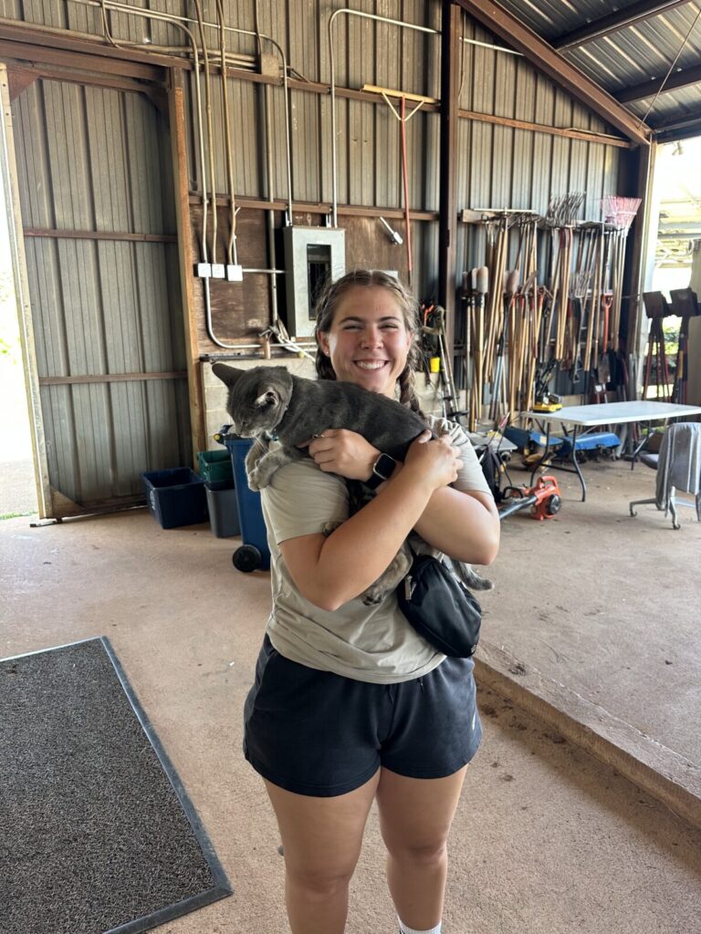 headshot of Faith holding the farm cat